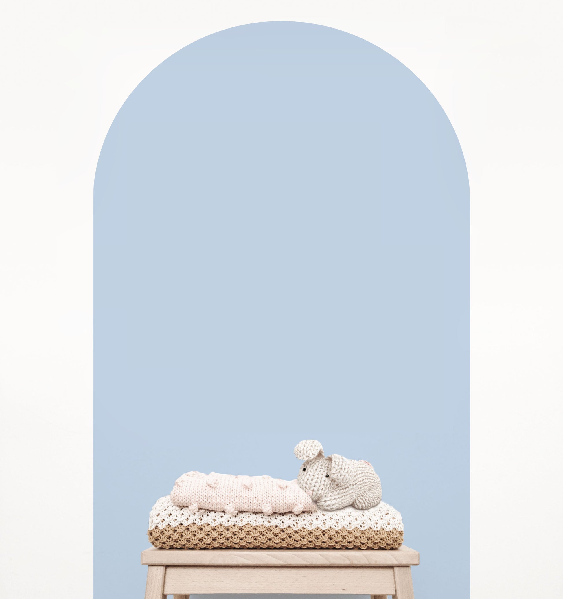 Baby blue arch wall decal creating a soft feature wall in a modern nursery