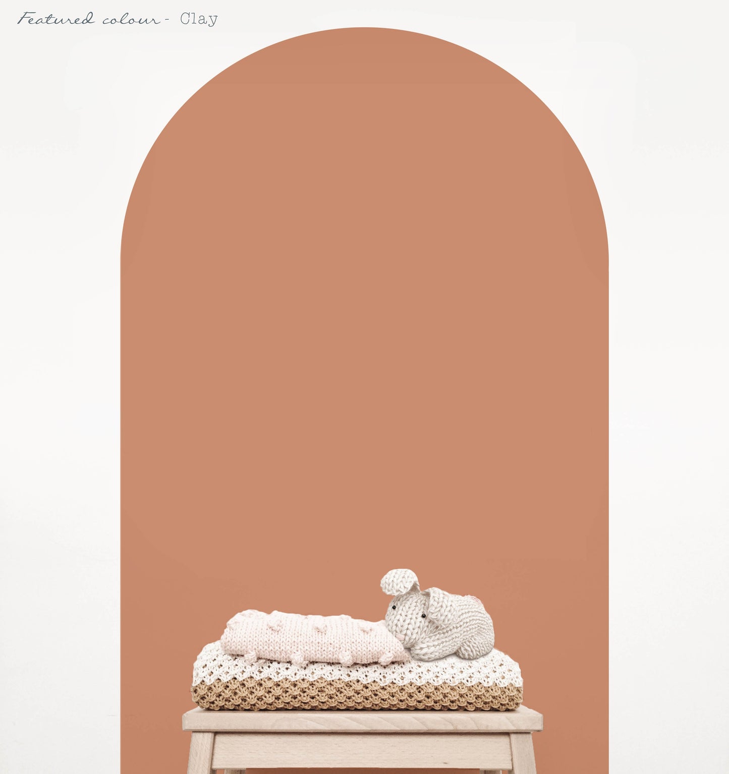 Clay arch wall decal in a warm earthy nursery with natural timber furniture