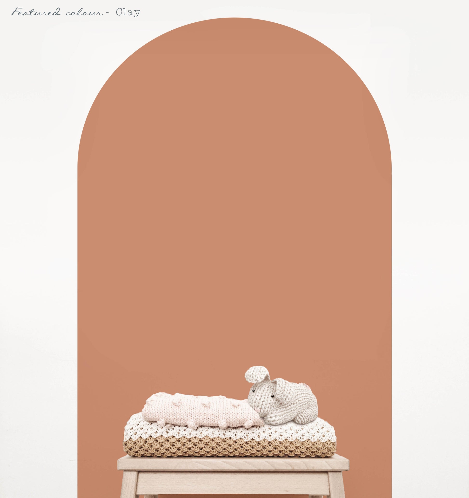 Clay arch wall decal in a warm earthy nursery with natural timber furniture