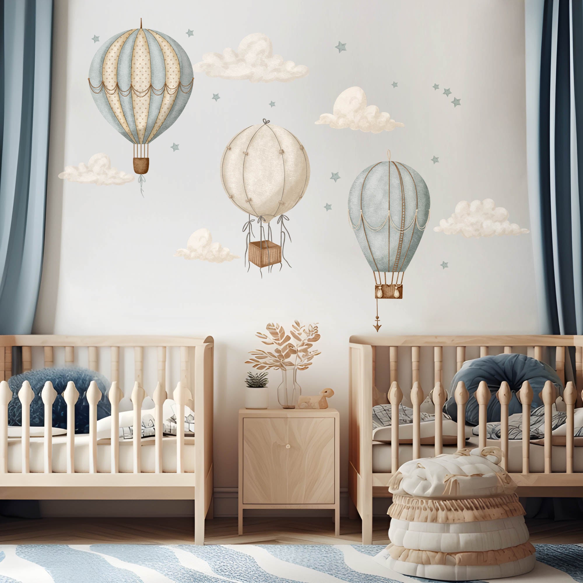 Watercolour hot air balloon wall stickers in a modern nursery featuring three balloons, floating clouds and stars.