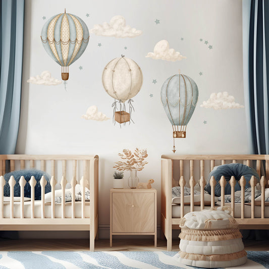 Watercolour hot air balloon wall stickers in a modern nursery featuring three balloons, floating clouds and stars.