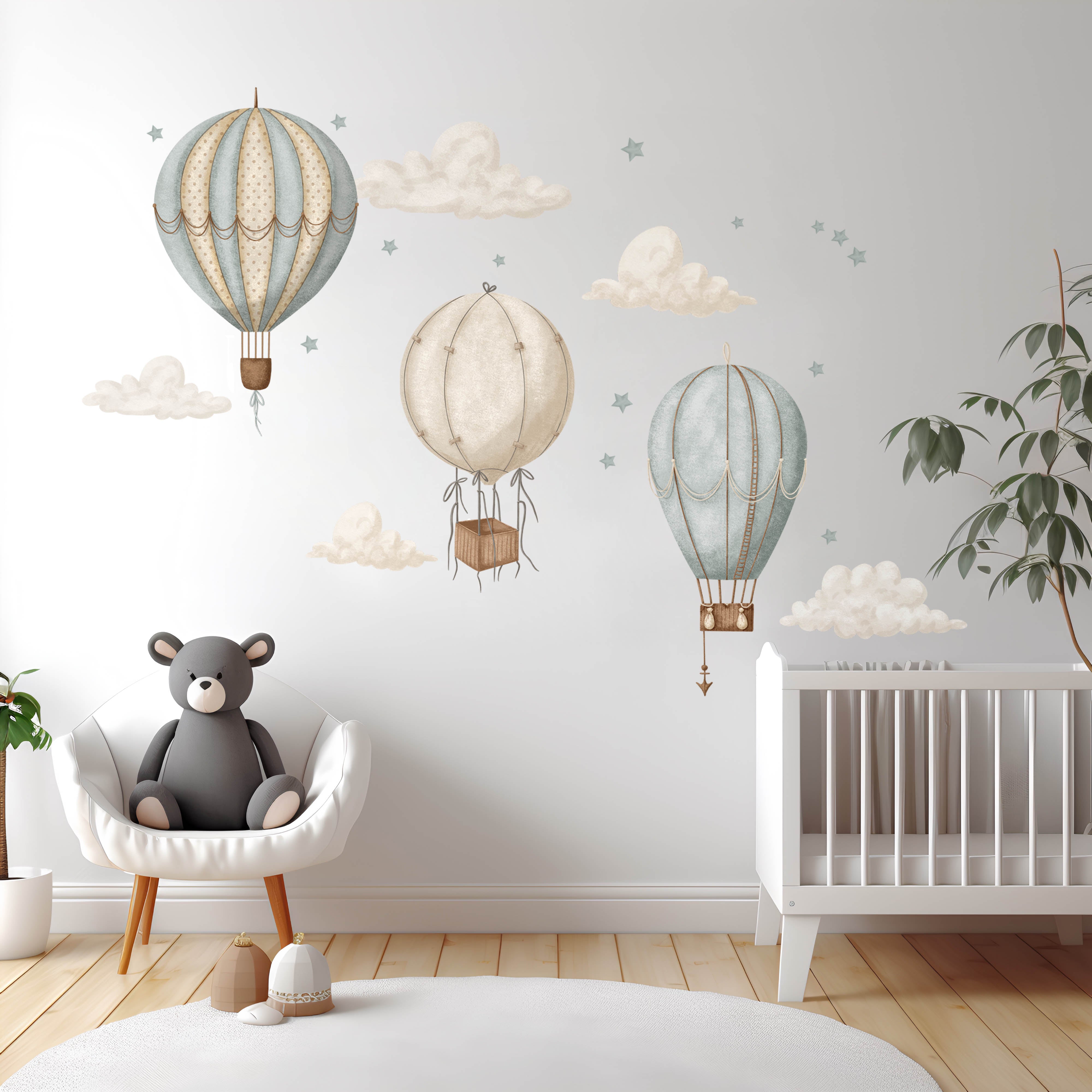 Watercolour hot air balloon wall stickers in a modern nursery featuring three balloons, floating clouds and stars. 