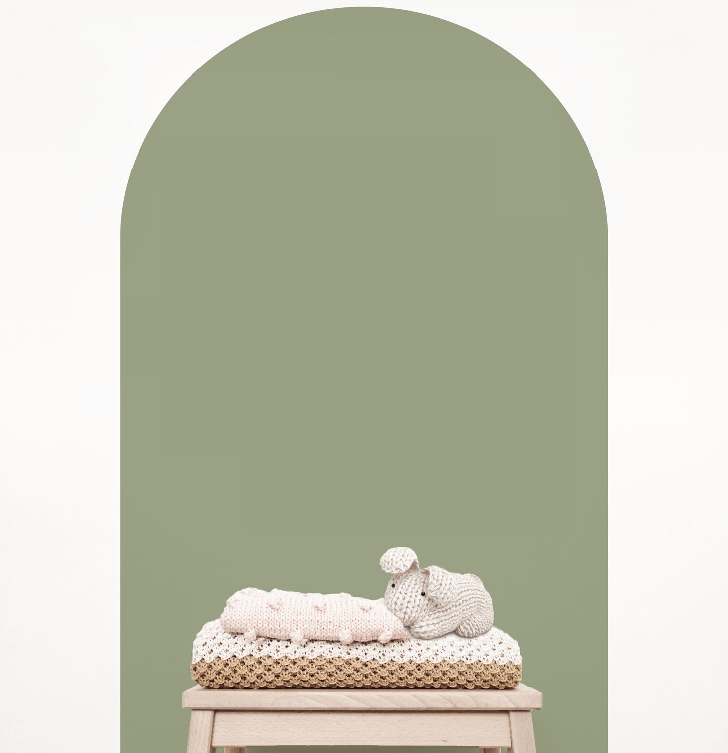 Olive green arch wall decal creating a warm earthy feature wall in a modern nursery