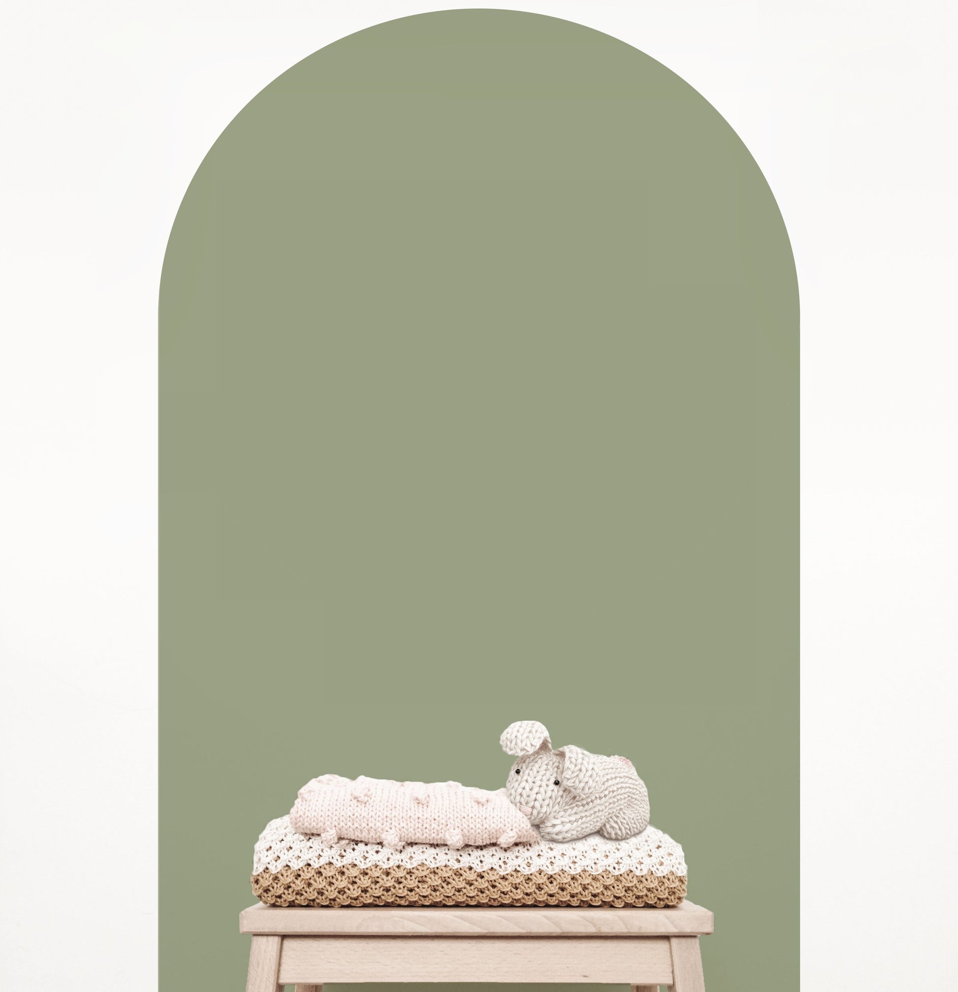 Olive green arch wall decal creating a warm earthy feature wall in a modern nursery