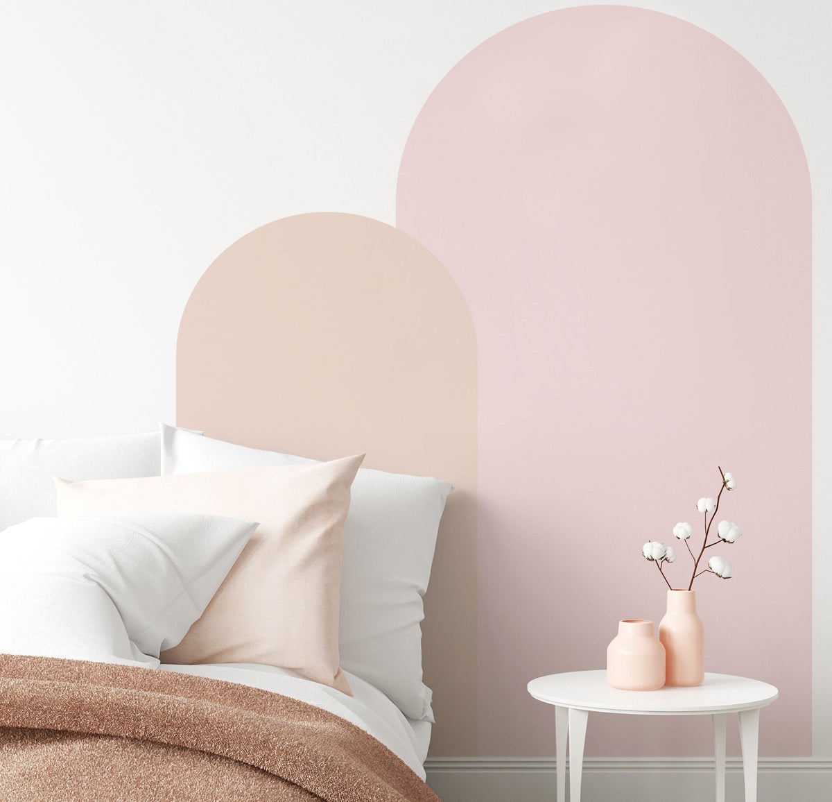 Pink arch wall decal in a nursery creating a soft pastel feature wall