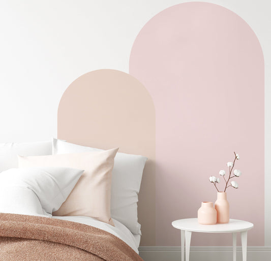 Pink arch wall decal in a nursery creating a soft pastel feature wall