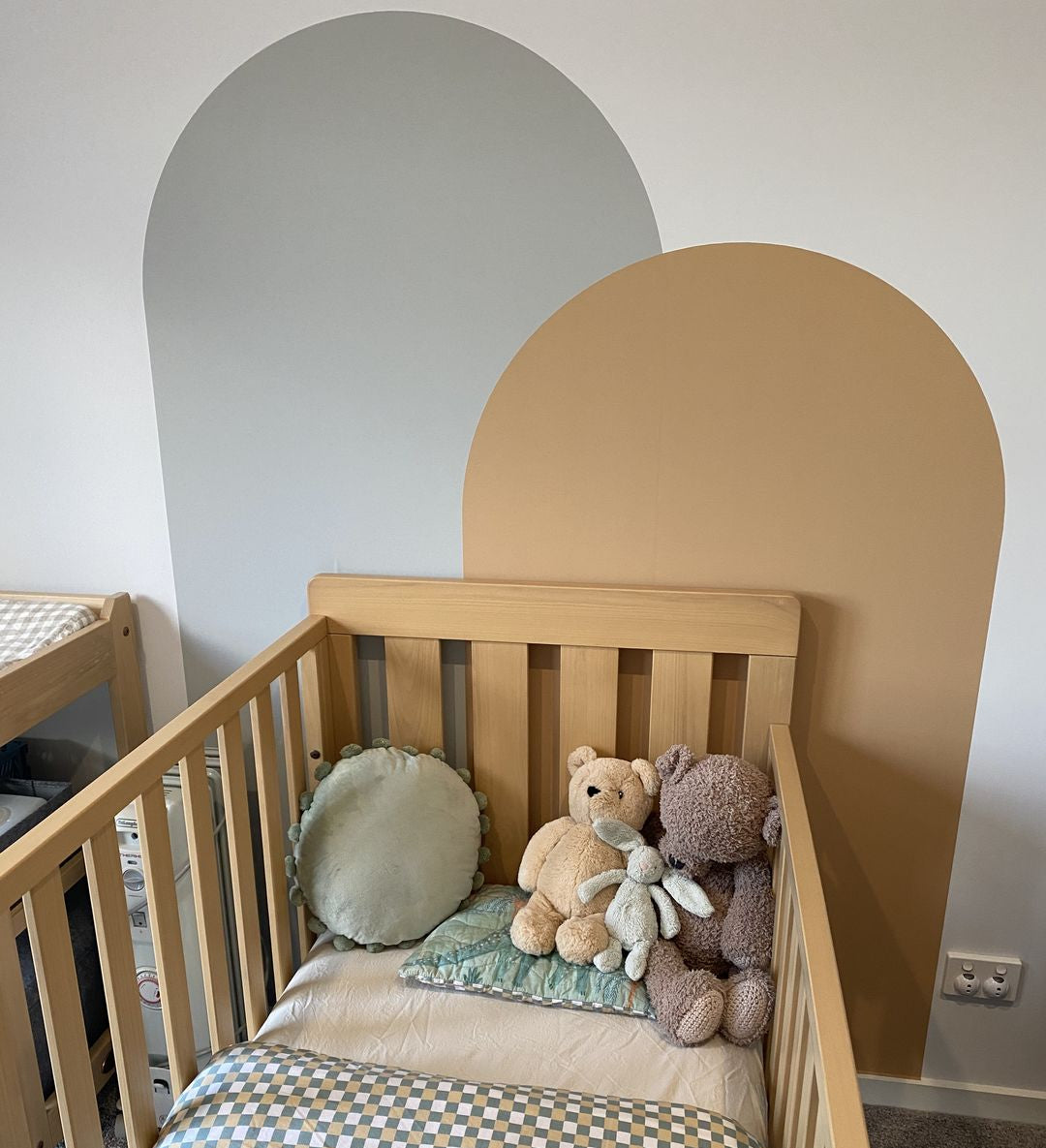 Rust arch wall decal paired with sage arch decal, creating a warm earthy feature wall in a modern nursery