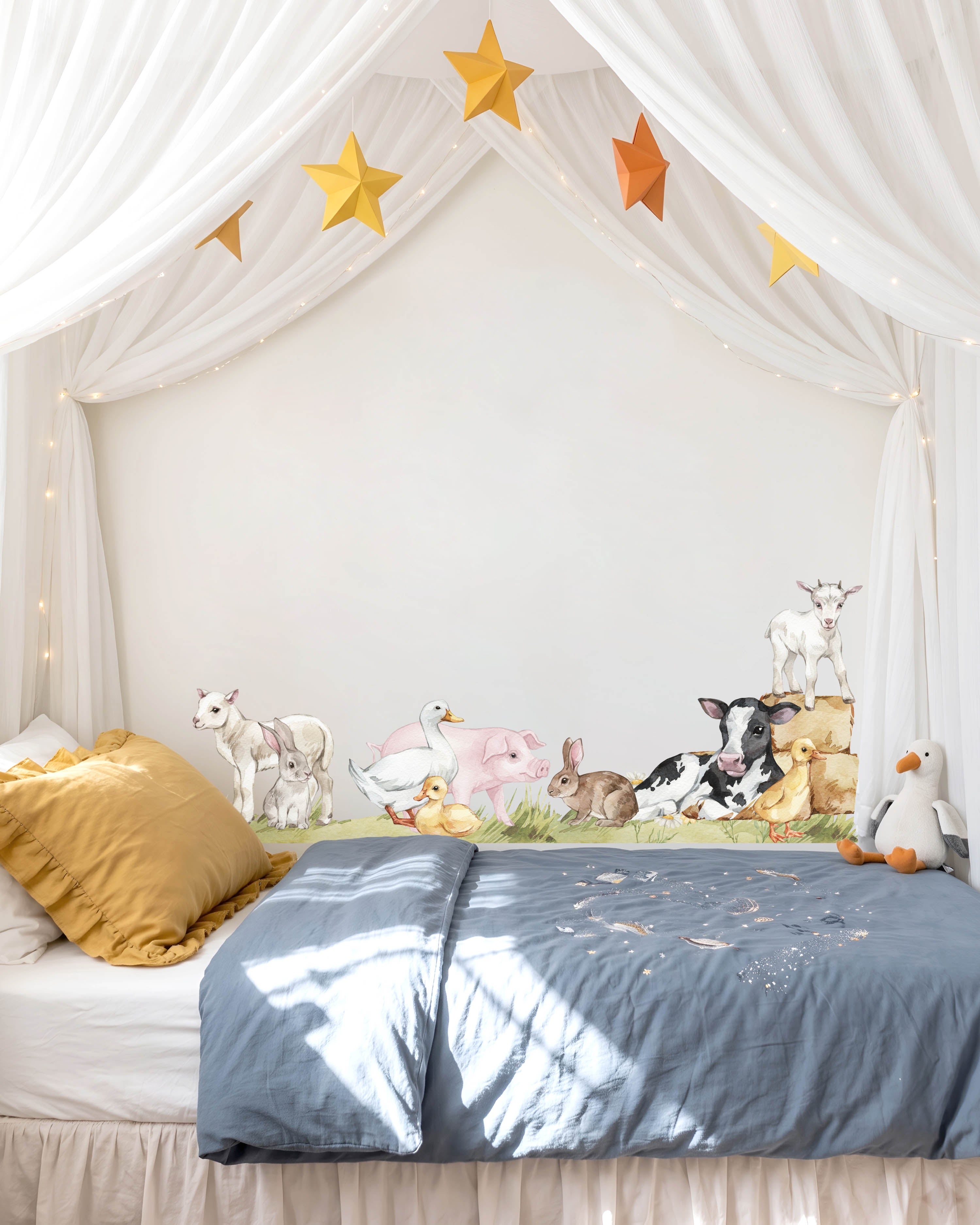 Farm animal wall decals above a bed in a big kids room
