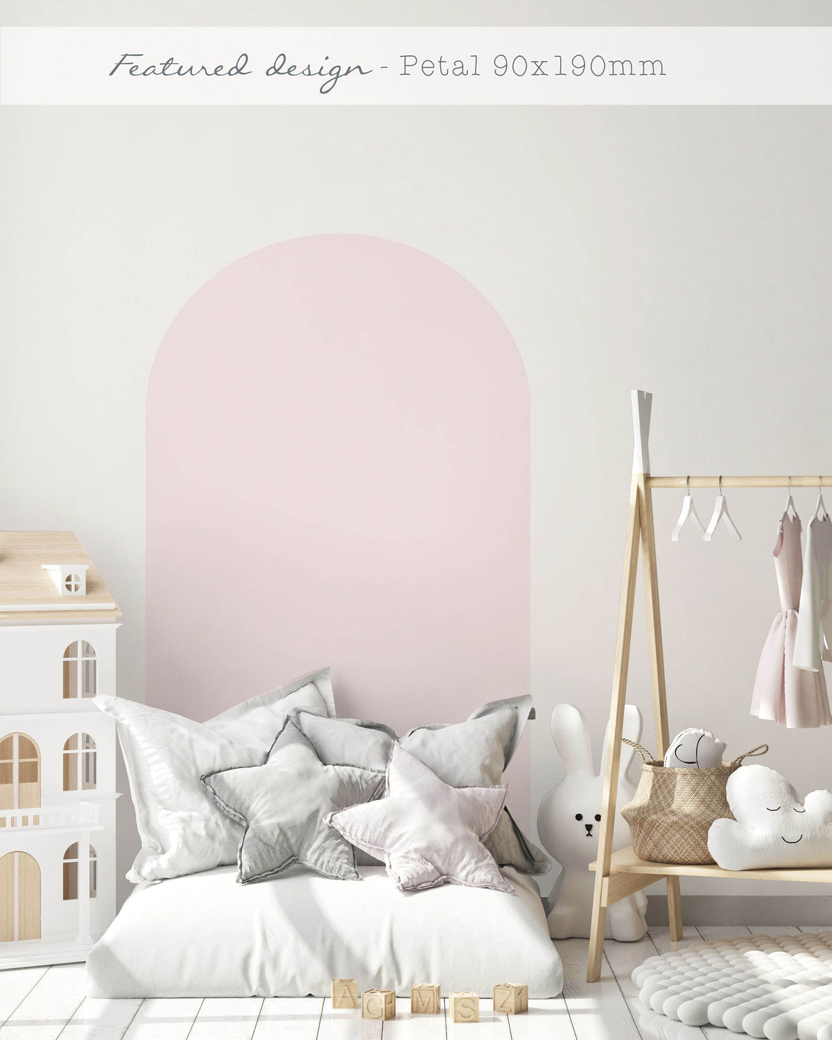 Pink arch wall decal in a nursery creating a soft pastel feature wall