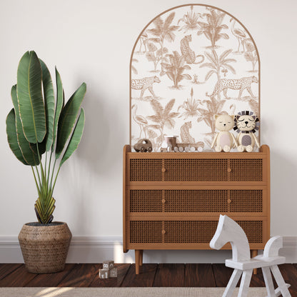 Clay Leopard Safari Arch Wall Decal behind a rattan bed in a modern safari nursery with removable fabric wall stickers